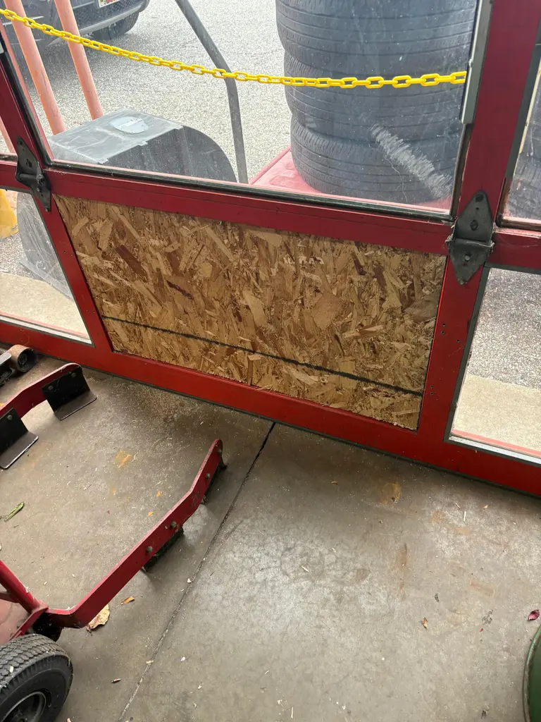 Board-up panel securing a storefront opening