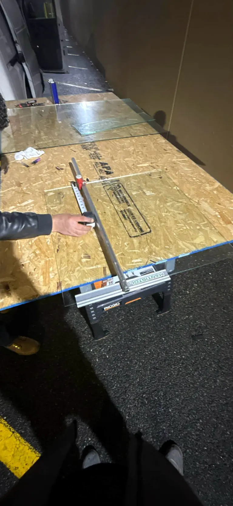 Glass cutting and measurement at a workbench