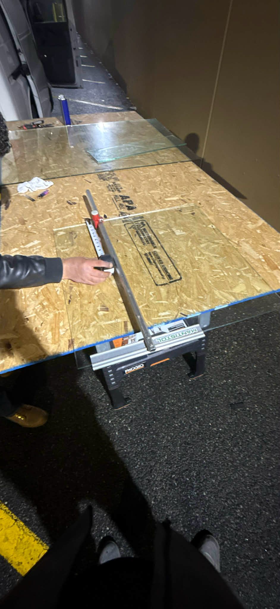 Glass measuring and cutting at a workbench