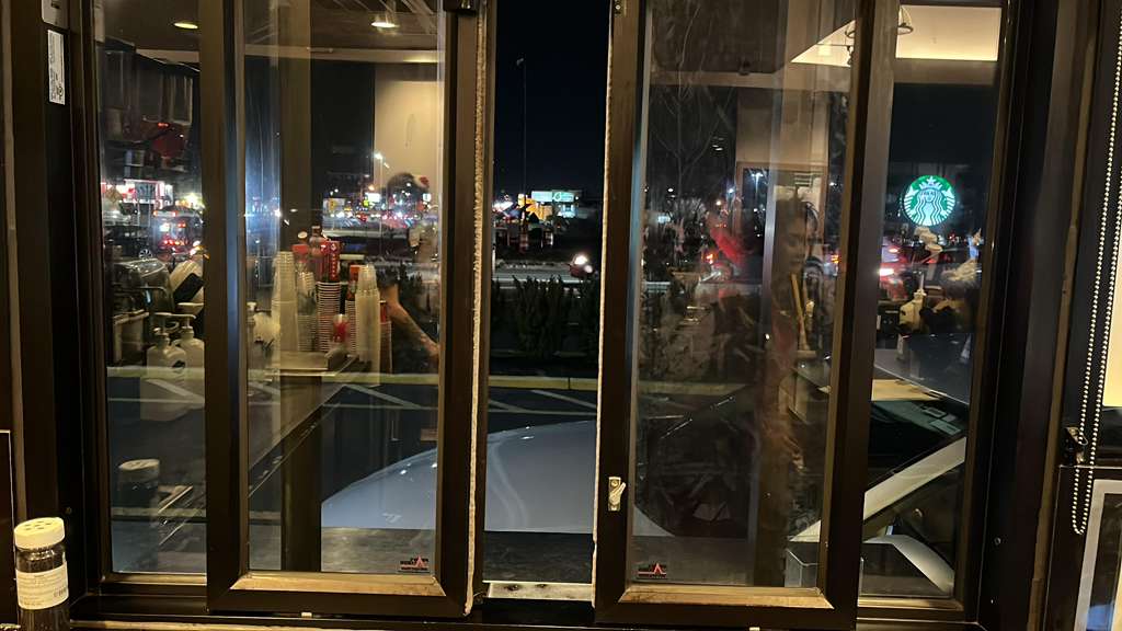 Storefront interior view through glass at night