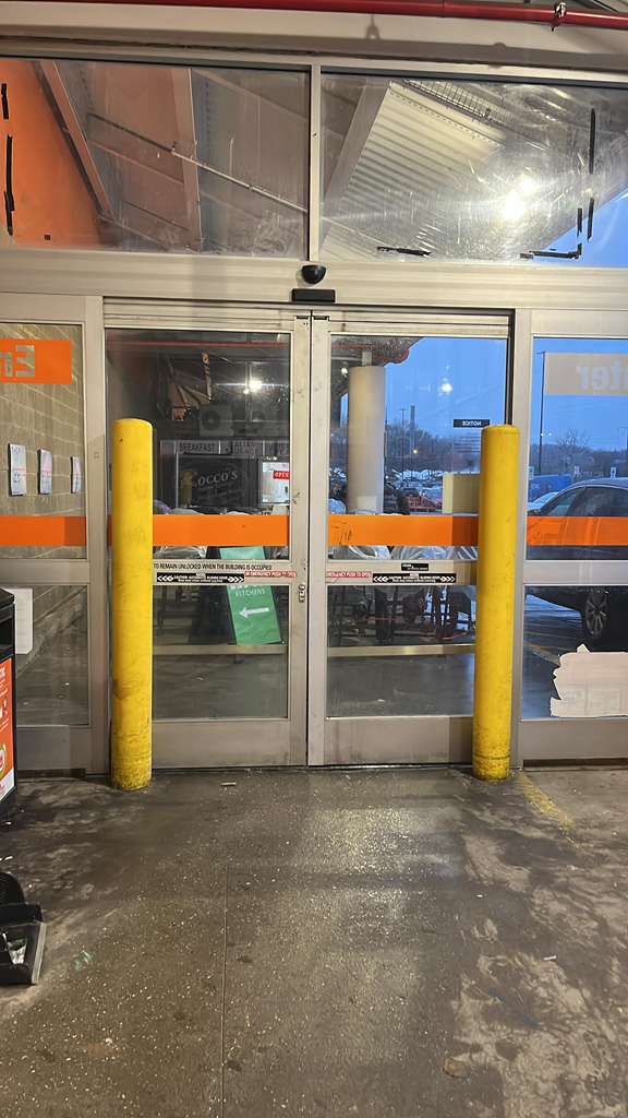 Storefront entry with damaged transom glass above the doors